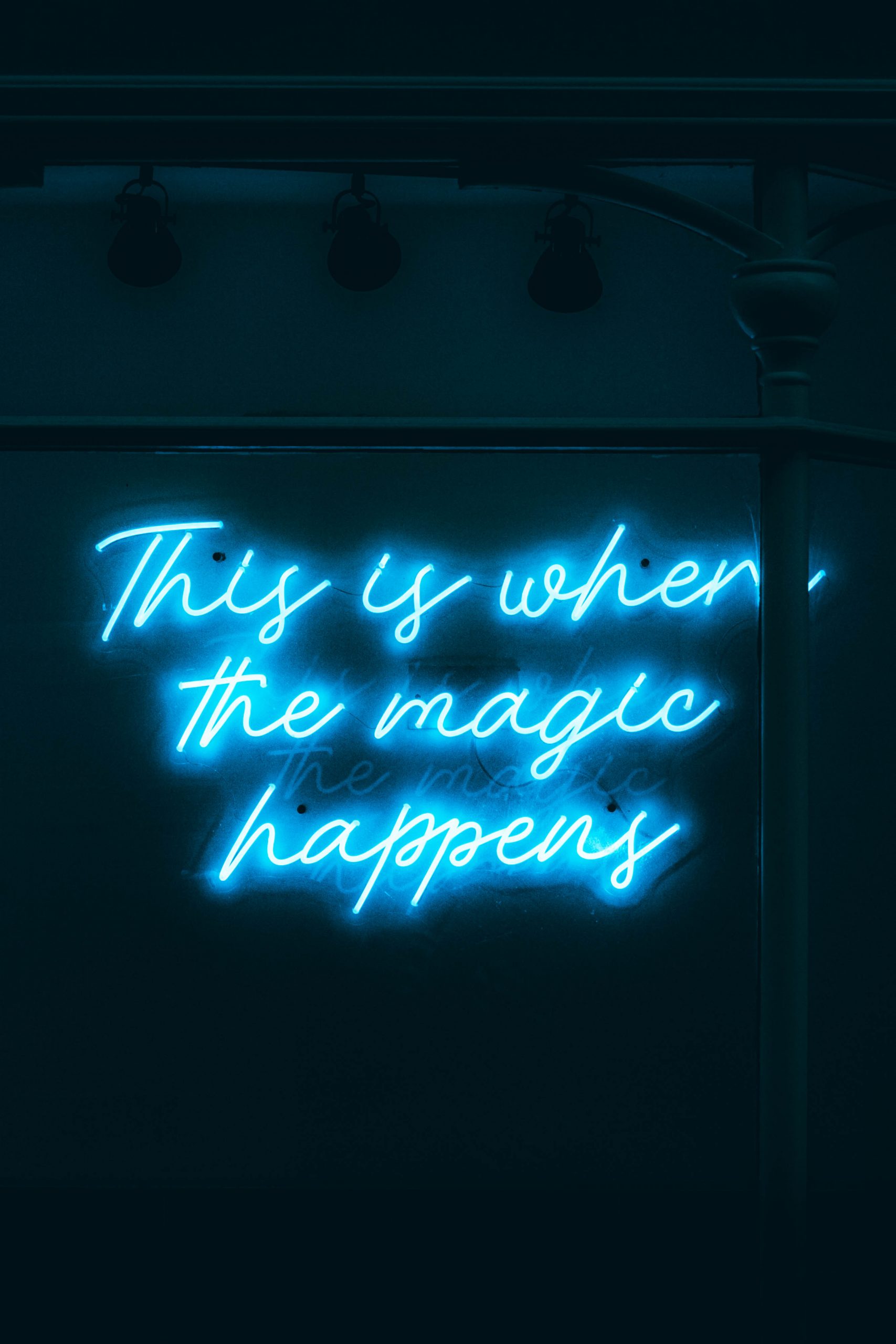 'This is where the magic happens' neon sign